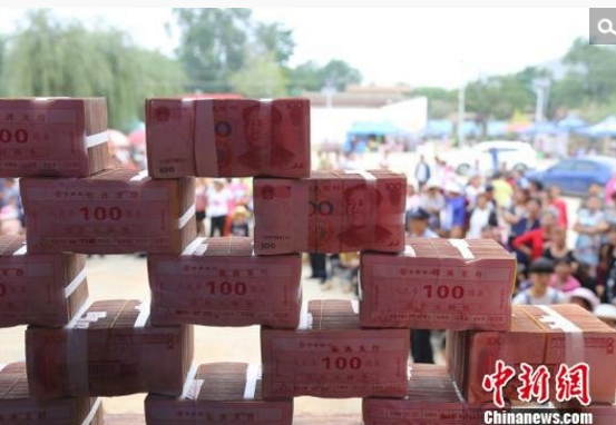 　　甘肃临洮县素有“貂蝉故里”、“中国花木之乡”之称。2000年，响应国家退耕还林的政策，边国胜在农行贷款30万元尝试种植苗木，建立苗木公司。2012年边国胜成为机场村村支书，他带领村里人谋求致富路径，和村里的村民合伙种植苗木，效益实施五五分成，早先行动的部分村民由原来的种菜种庄稼改为种树苗，年收益大幅提高，有的年收益超过10万元。图为村民都来围观。